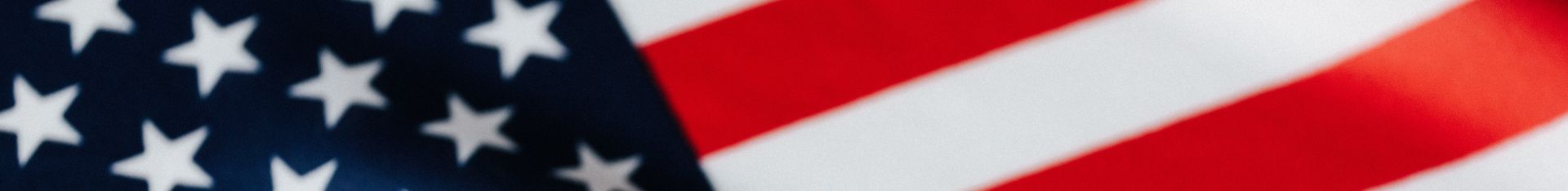 From above of closeup flattering national flag of USA with white and red stripes and stars on blue background